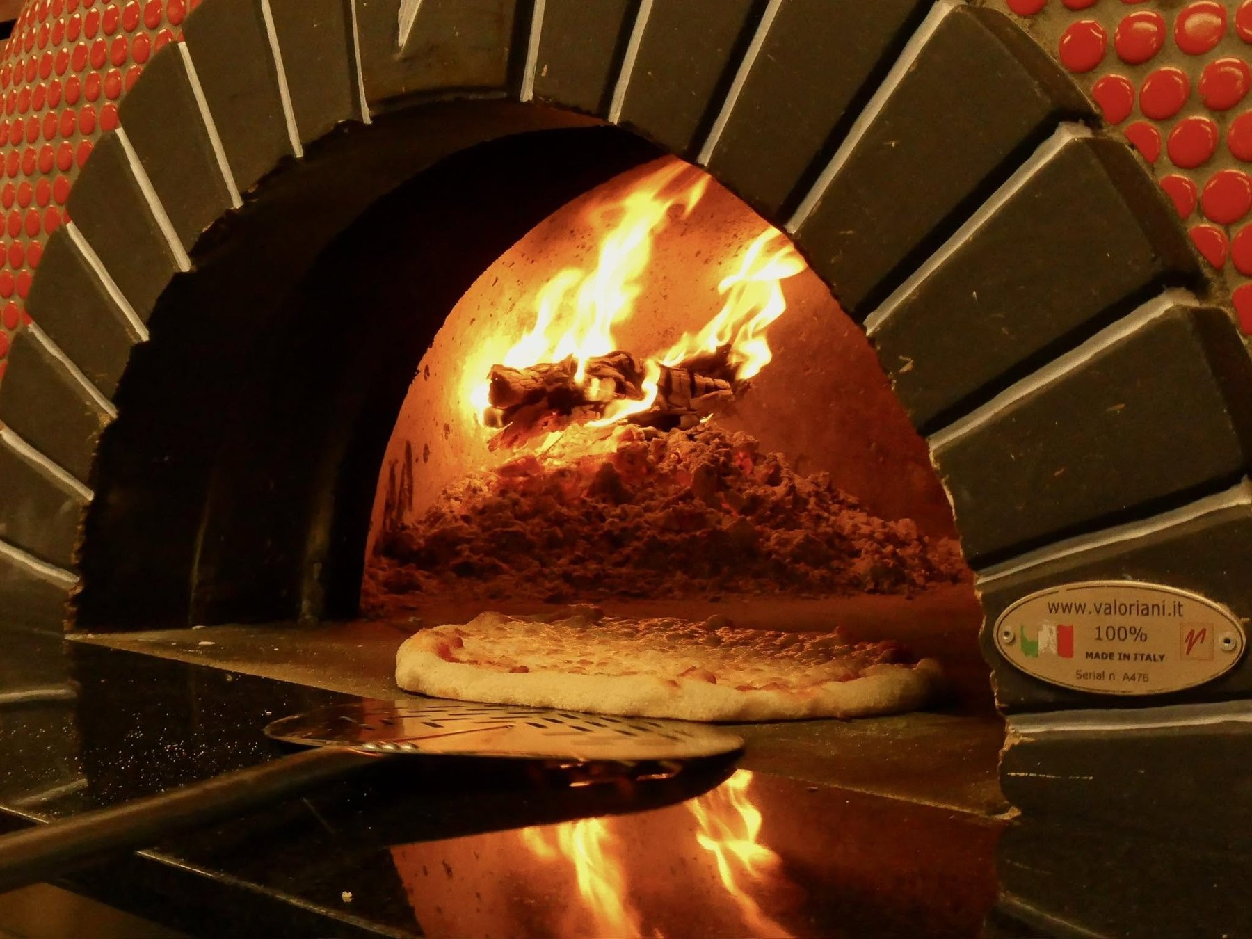 Wood fired pizza baking in Mama Tina's oven in Wenatchee