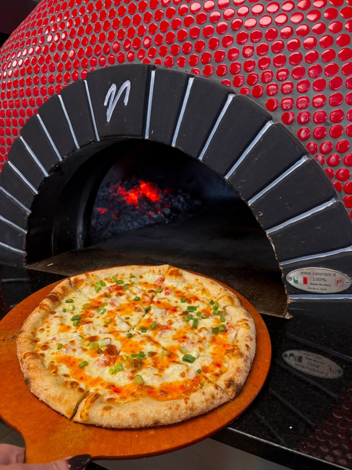 Pizza beside the red tiled wood oven at Mama Tina's in Wenatchee